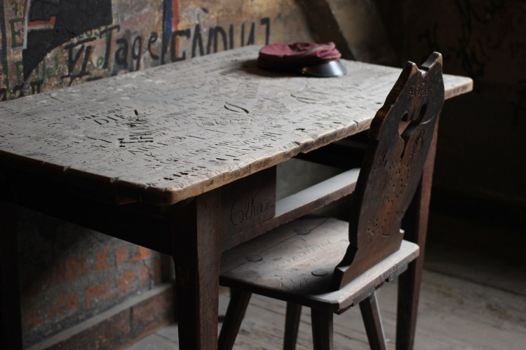 A cell in the Karzer Student Prison. Students passed the time by graffitiing the walls. A favourite technique was to emulate the student's profile.